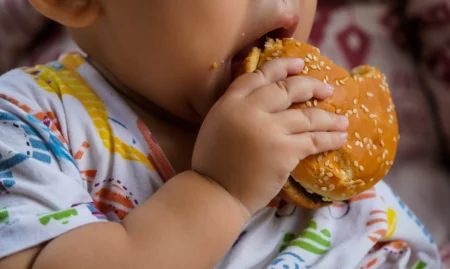 midsection-baby-holding-hamburger-scaled-1-2048x1152